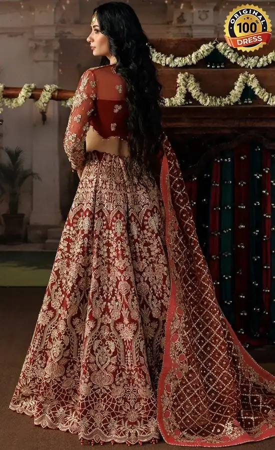 Embroidered orange lehenga choli for wedding guests with sequinned work and tassel detailing