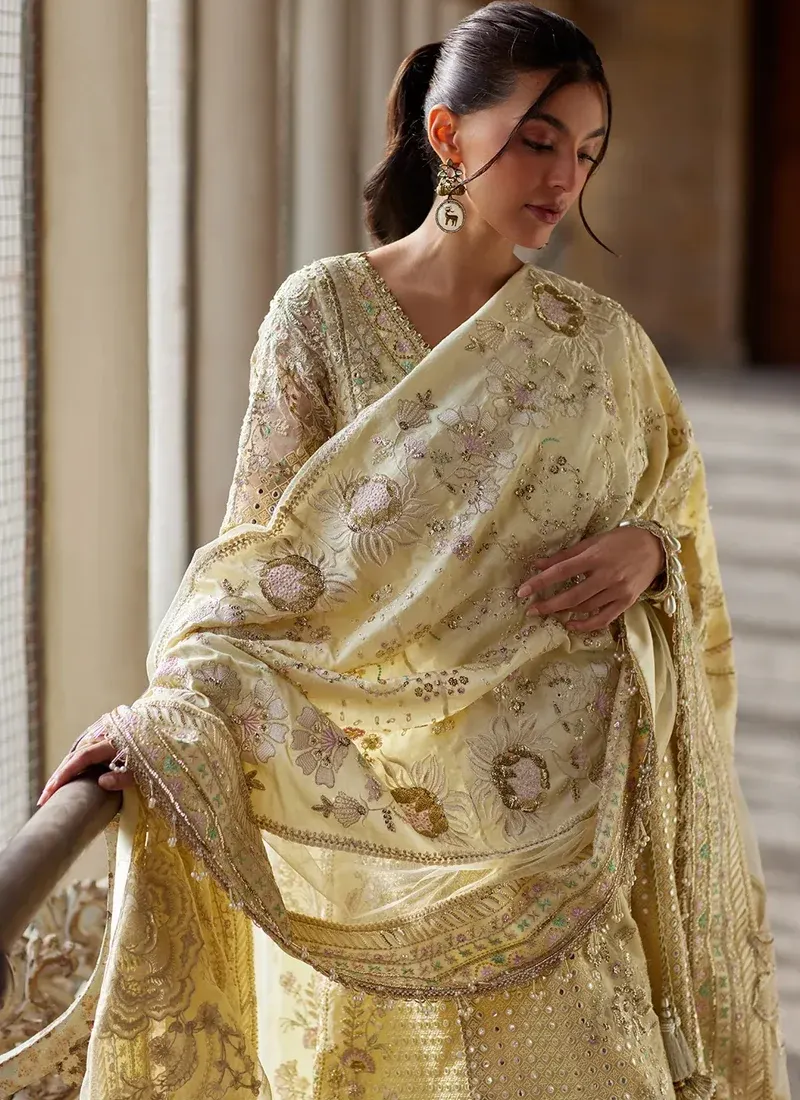 Yellow shalwar kameez featuring organza details, embroidery and tassel embellishments