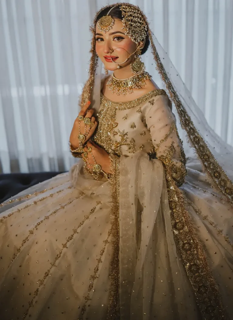 Pakistani ivory gold bridal gown with luxurious embroidery and graceful floor-length silhouette