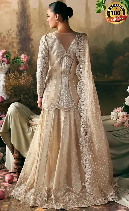 Embroidered beige lehenga for wedding guests with tassels, samosa lace and patchwork detailing