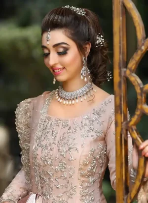 Baby pink Nikkah gown in tissue silk with 12 kalis, boat neckline, full sleeves and organza dupatta.
