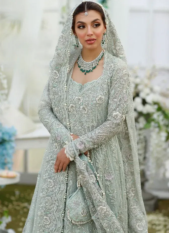 Aqua green bridal frock and lehenga with silver hand embroidery, attached cancan and long trail.