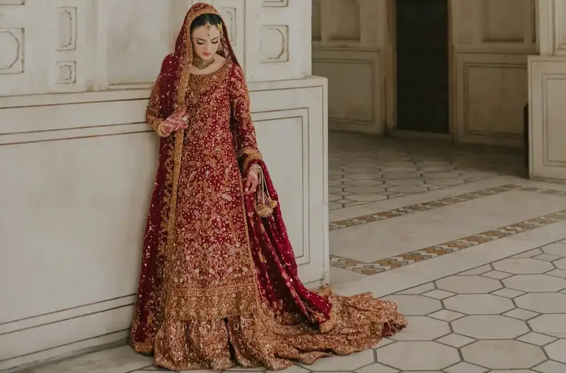 Pakistani bride wearing a floor-sweeping Farshi lehenga