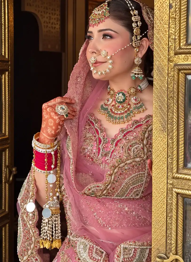 Baby pink wedding lehenga with crystal embellishments and traditional bridal embroidery