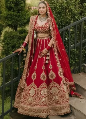 Deep ruby red bridal lehenga choli with a sweetheart blouse, pendant embroidery and antique-gold arch border