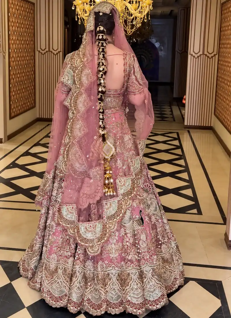 Embroidered baby pink bridal lehenga choli with intricate crystal and dabka embellishments