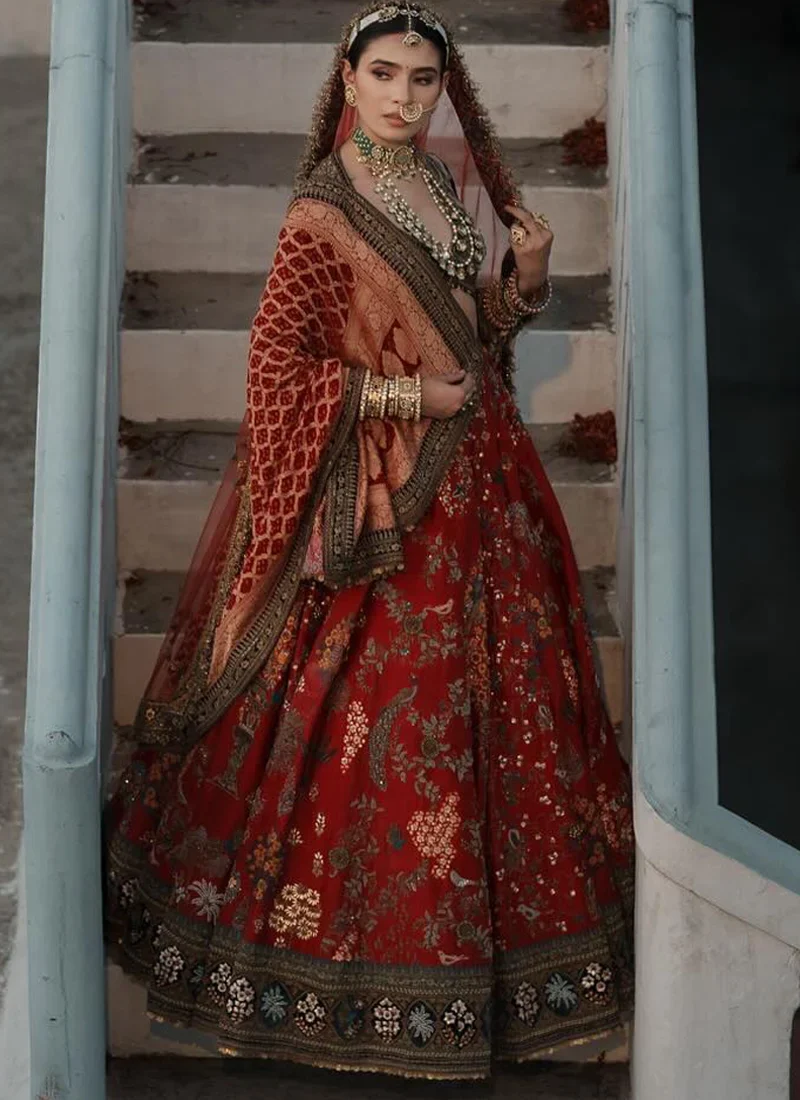 Indian velvet bridal lehenga in vermilion red and forest green with intricate multicolour heritage motifs