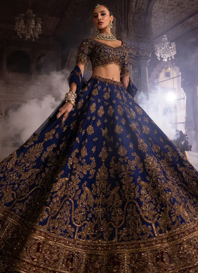 Navy blue bridal lehenga choli with elegant peacock motifs and detailed gold embroidery