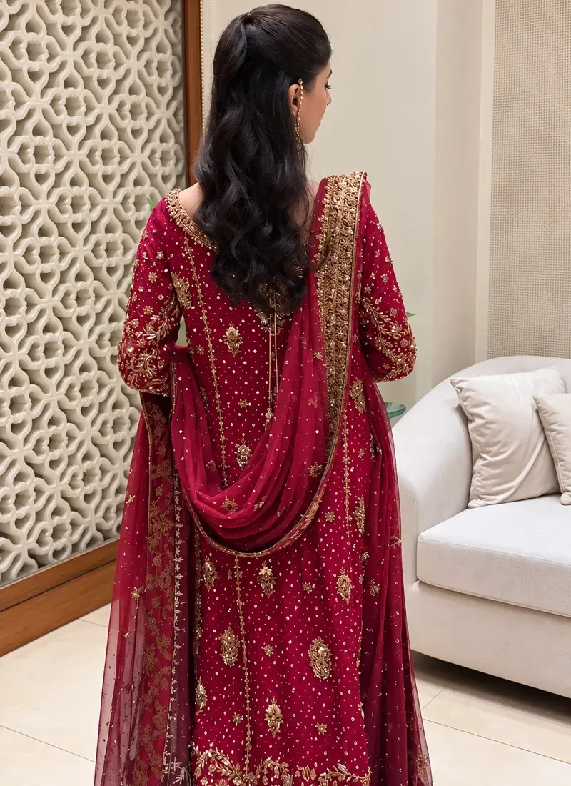 Ruby red Pakistani formal dress with keyhole neckline, full sleeves and gold zardozi, dabka, kora and cutdana work