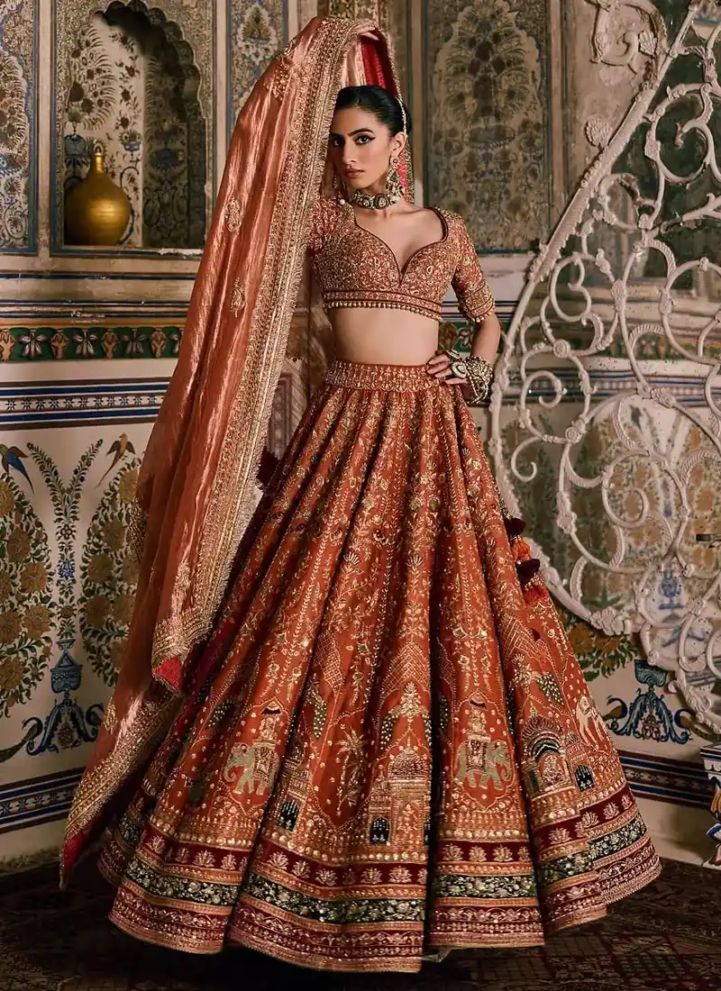 Rust brown bridal lehenga featuring detailed zardozi work and elegant resham embroidery