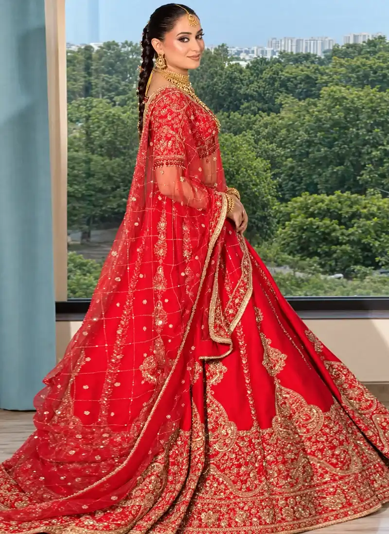 Scarlet red bridal lehenga featuring intricate gold paisley embroidery and elegant traditional detailing