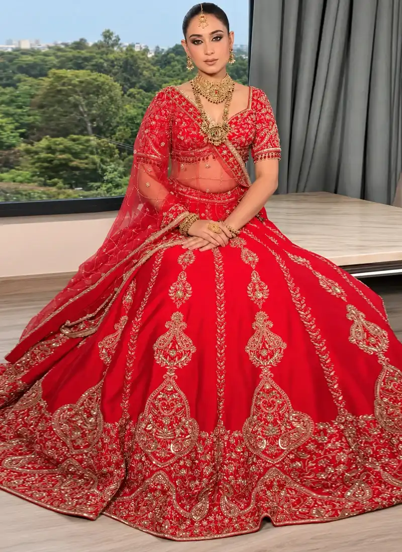 Scarlet red Indian bridal lehenga choli with gold paisley embroidery and a beaded blouse