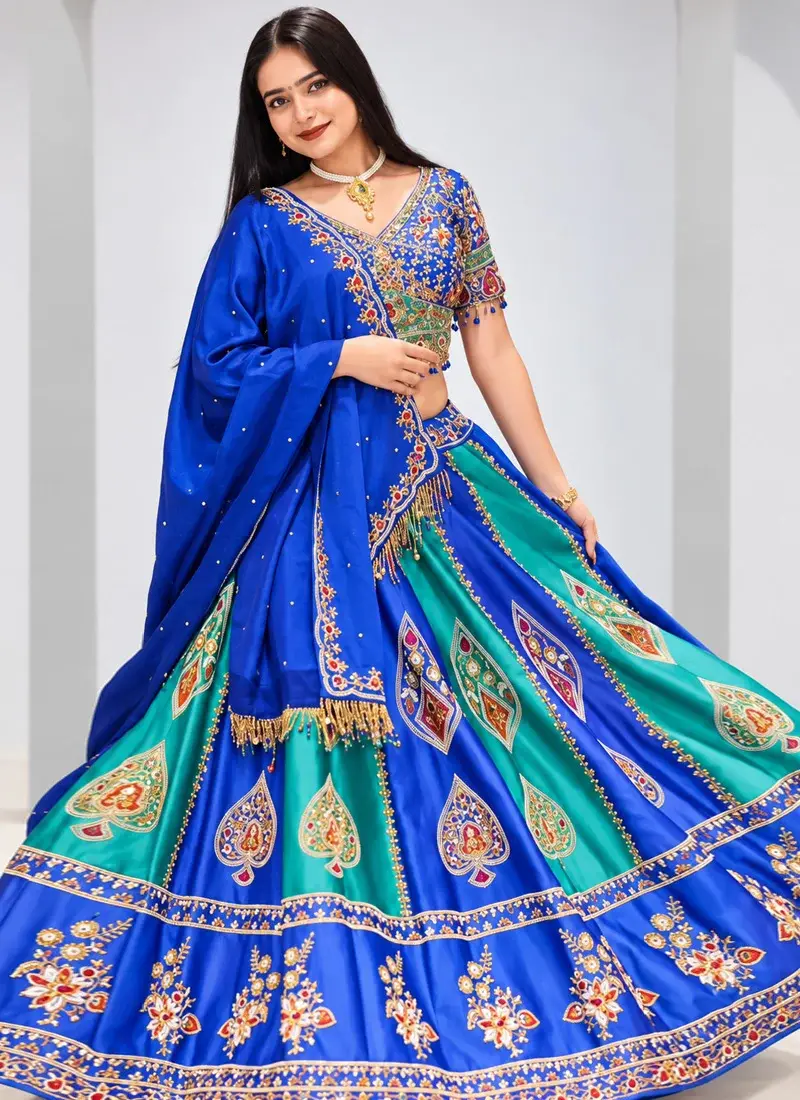 Teal green and royal blue bridal lehenga choli with multicolour motifs and festive wedding styling