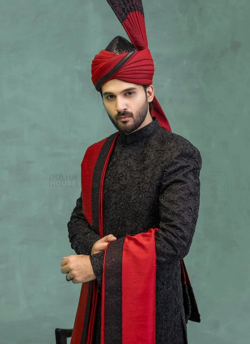 Traditional black wedding sherwani with red shawl and turban for elegant groom styling