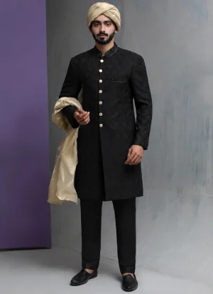 Traditional black wedding sherwani with gold shawl and turban for elegant groom styling