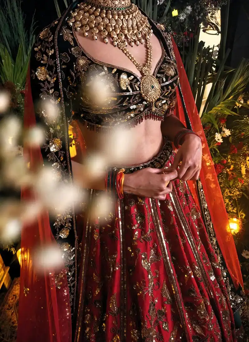 Velvet bridal lehenga choli in crimson red with black blouse and detailed antique zardozi work