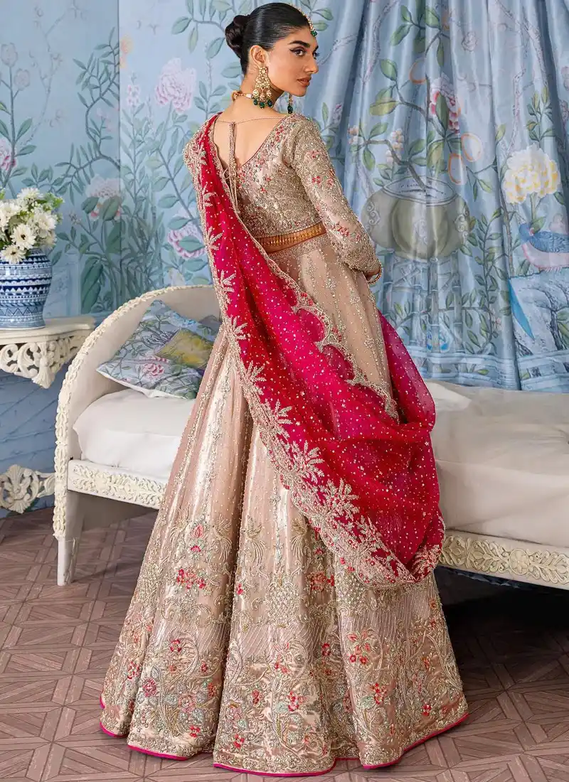 Rose beige bridal lehenga choli back view with deep V neckline, gold floral embroidery and fuchsia dupatta