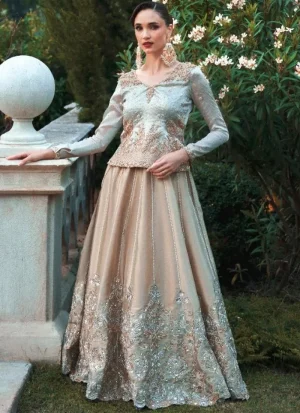 Champagne lehenga with pale aqua blue top, seated front view showing a scalloped floral hem