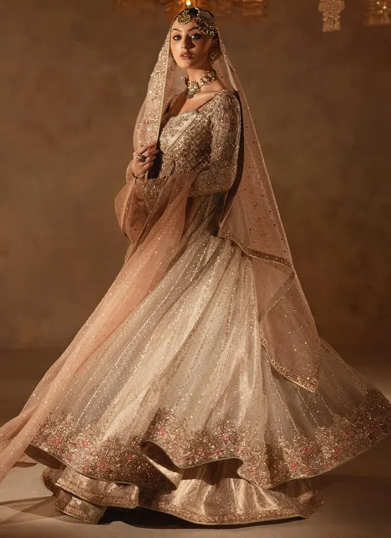 Champagne bridal angrakha and lehenga full-length front view with wide floral hem and pink dupatta