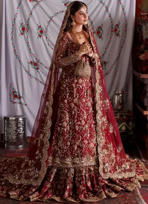 Deep red farshi lehenga side view with gold floral embroidery and scalloped net dupatta border