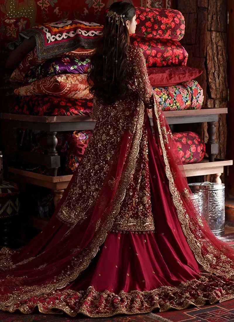 Deep red farshi lehenga back view with embroidered long shirt and extended crimson bridal train