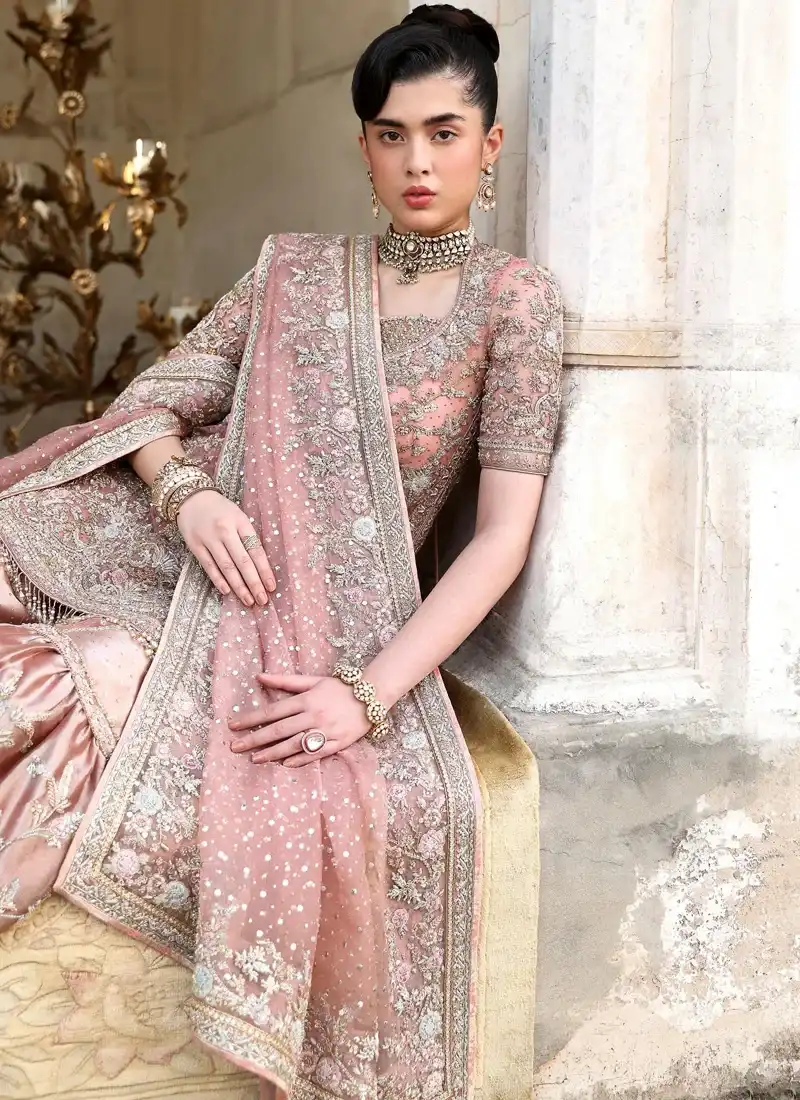 Dusty pink bridal gharara full front view with gathered tissue flares and a wide floral-bordered net dupatta.