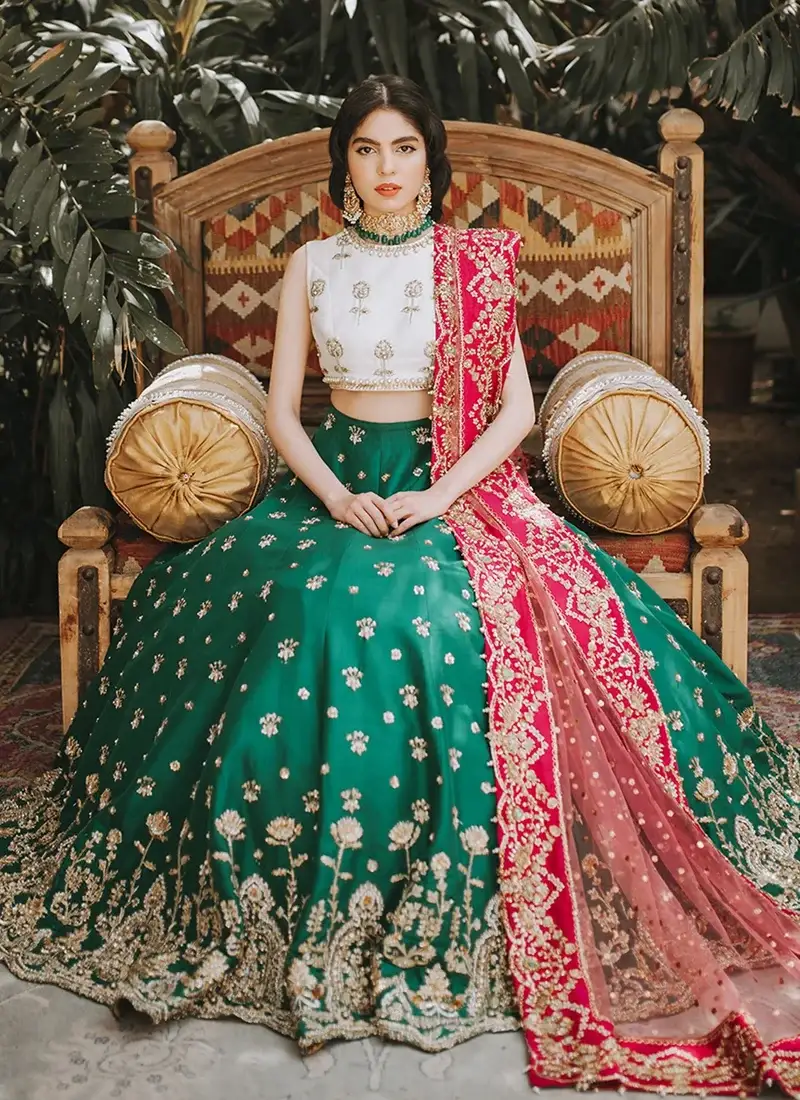 Emerald Green Mehndi Lehenga Choli with Pink Zardozi Dupatta Border Emerald green lehenga choli front view with white floral blouse and bright pink embroidered dupatta