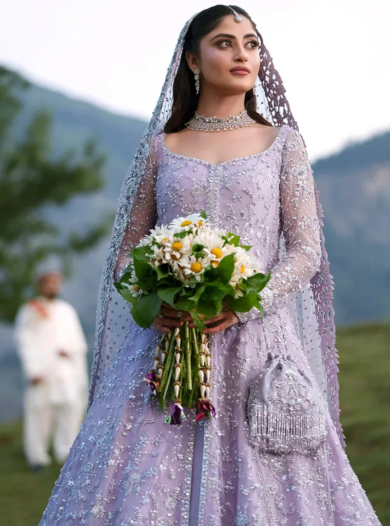 Close front view of lavender bridal gown with square neckline, sheer full sleeves and silver floral embroidery
