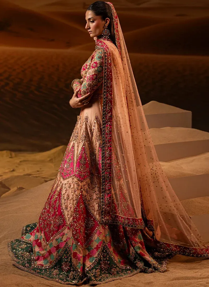 Peach bridal lehenga choli side-back detail with a sheer dotted dupatta and ornate pink border