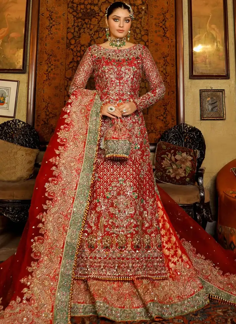 Red Baraat Long Shirt with Lehenga with Green-Trimmed Brocade Trail Red bridal long shirt and lehenga hem close-up with gold floral arches and a green embroidered border
