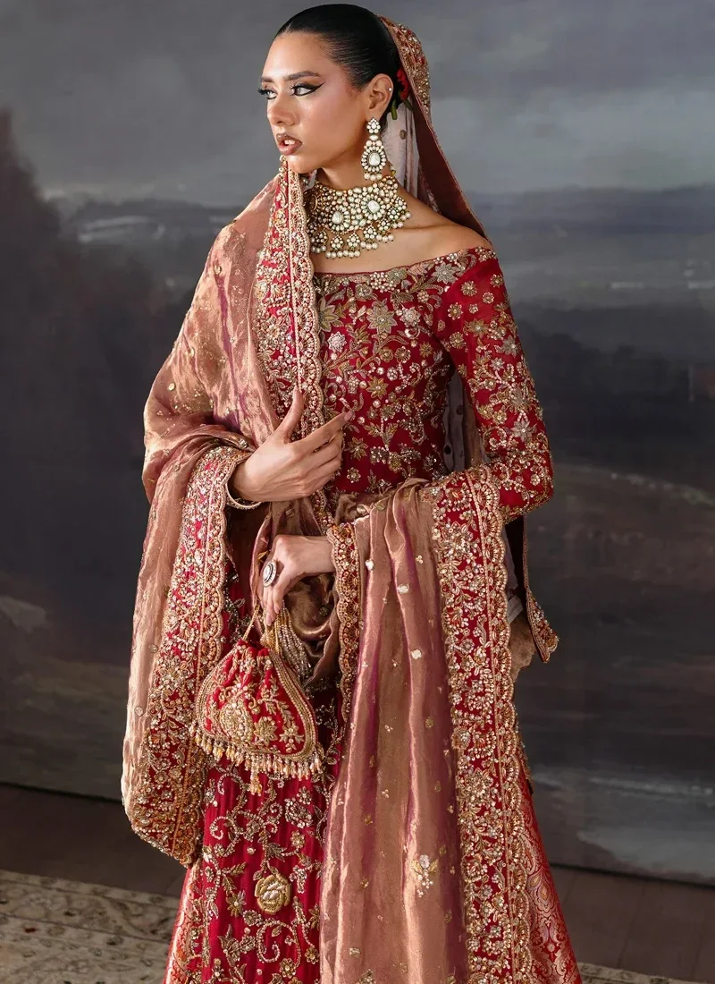 Red bridal long shirt front close-up showing an off-shoulder neckline and dense gold floral embroidery.