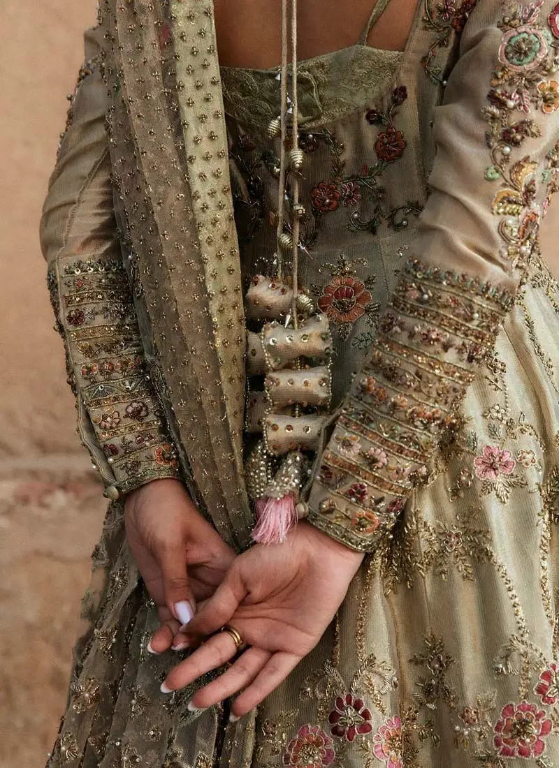 Sage green bridal pishwas close-up showing ornate embroidered cuffs, beaded back tassels and dotted net dupatta