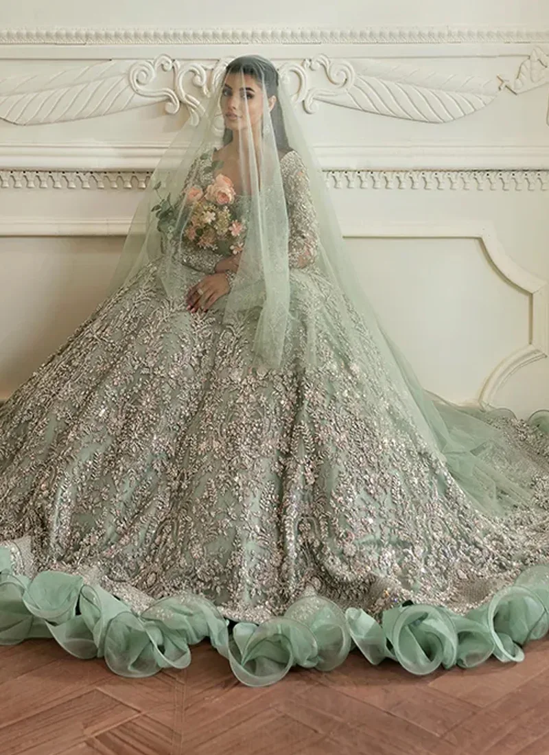 Sage green bridal maxi seated with sheer dupatta veil, silver embroidery and oversized spiral hem frills