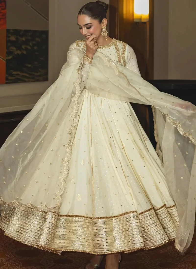 White and gold pishwas back view with diagonal beadwork, embroidered waist and flowing organza dupatta