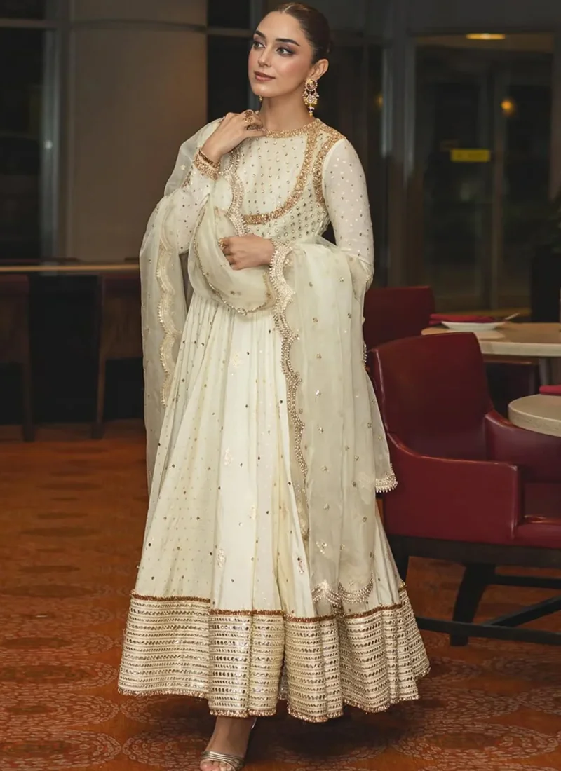 White formal pishwas front close-up with round neckline, gold curved embroidery and delicate beadwork