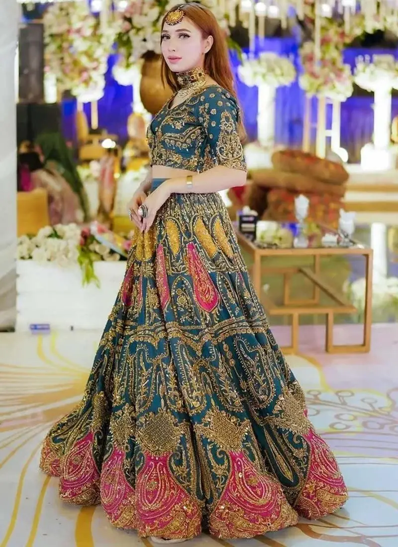 Zinc Blue Mehndi Lehenga Choli with Fuchsia Paisley Motifs Zinc blue choli side close-up showing intricate gold floral sleeve embroidery and decorative cuff